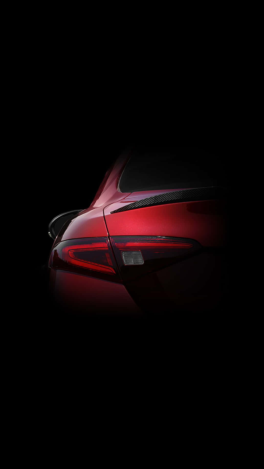 A Powerful, Sleek Red Car Against A Bright Blue Sky. Background