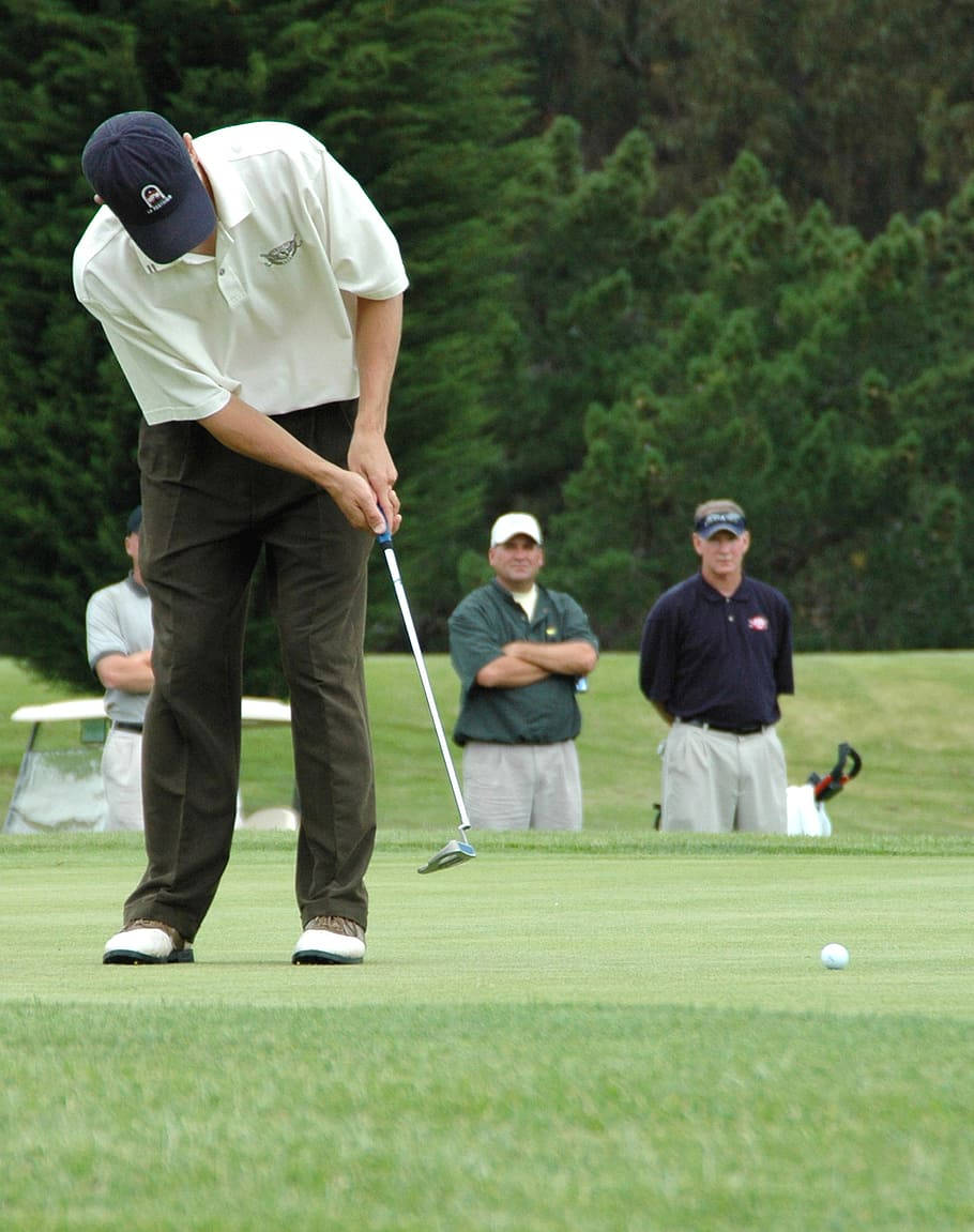 A Professional Golfer In Action During A Game Background