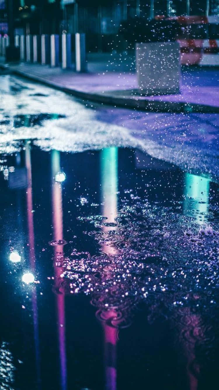 A Puddle Of Water On A Street At Night Background