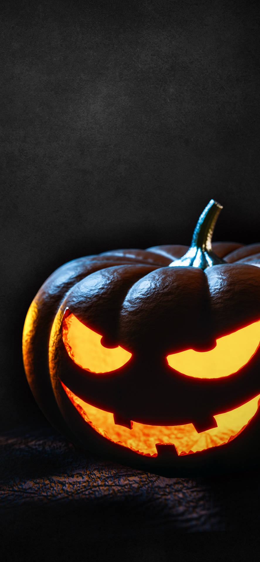 A Pumpkin With Glowing Eyes On A Dark Background