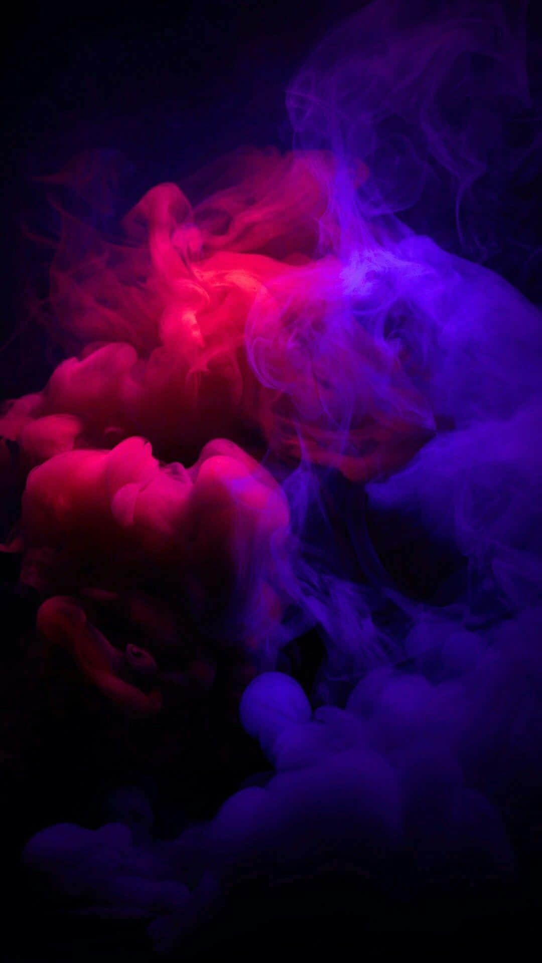 A Purple And Blue Smoke In The Dark Background
