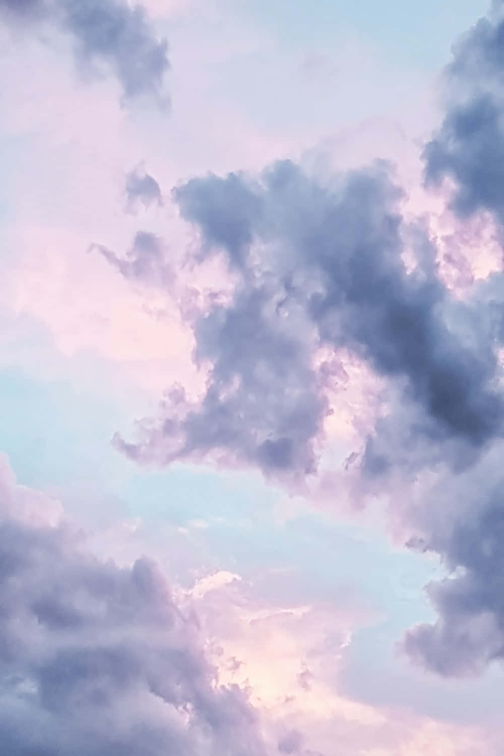 A Purple And Pink Sky With Clouds