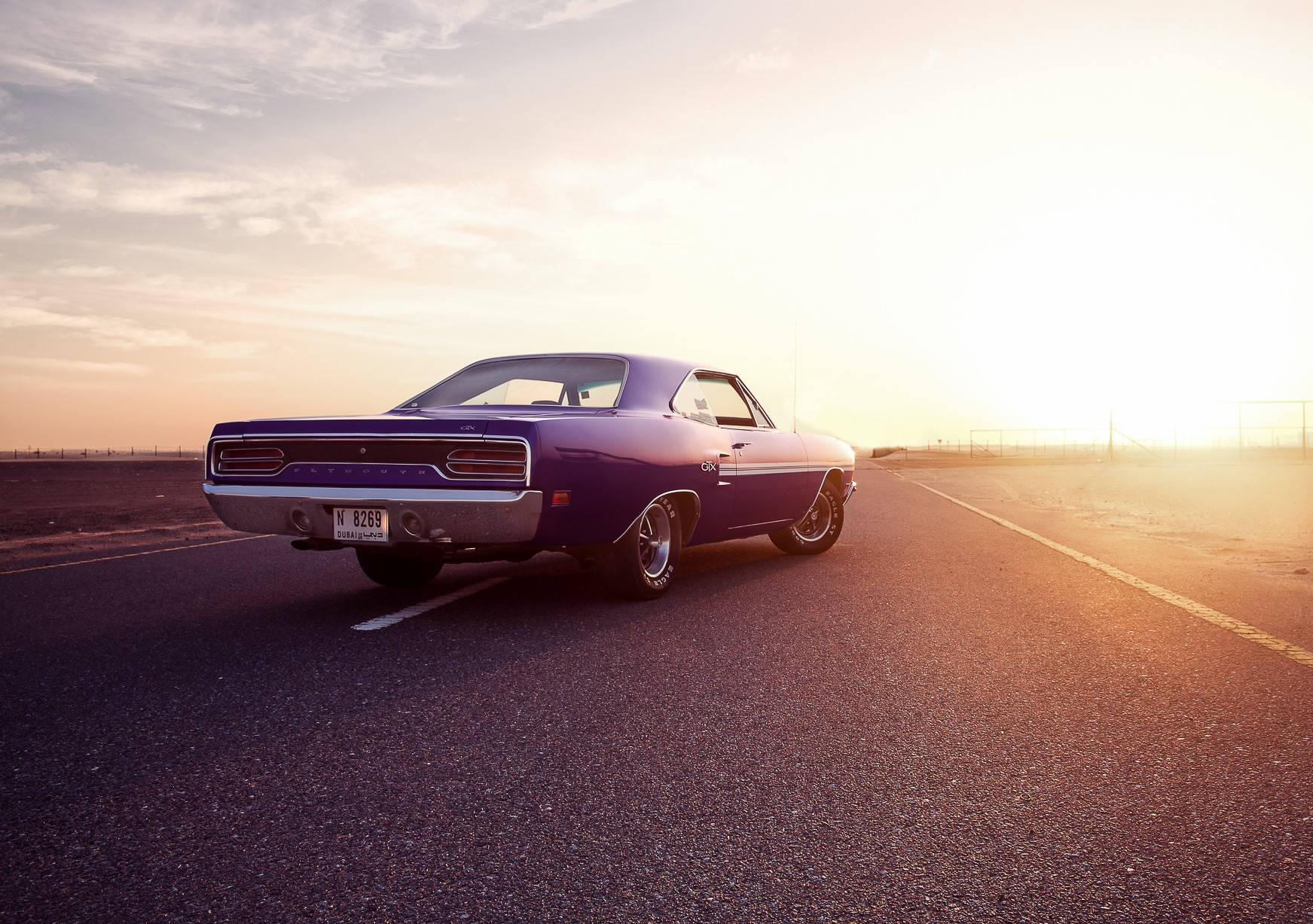 A Purple Car Is Driving Down The Road Background