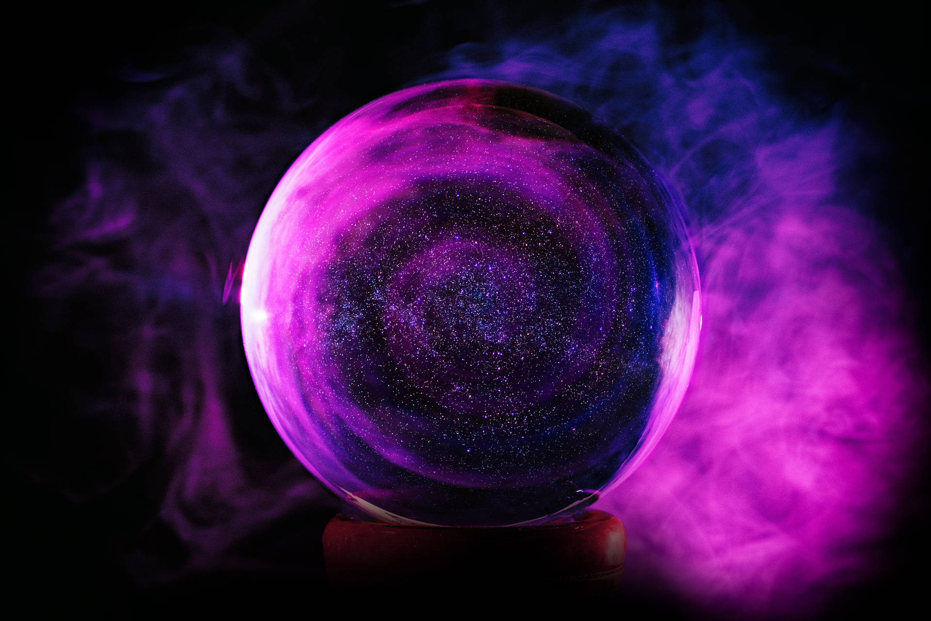 A Purple Crystal Ball With Smoke Coming Out Of It Background