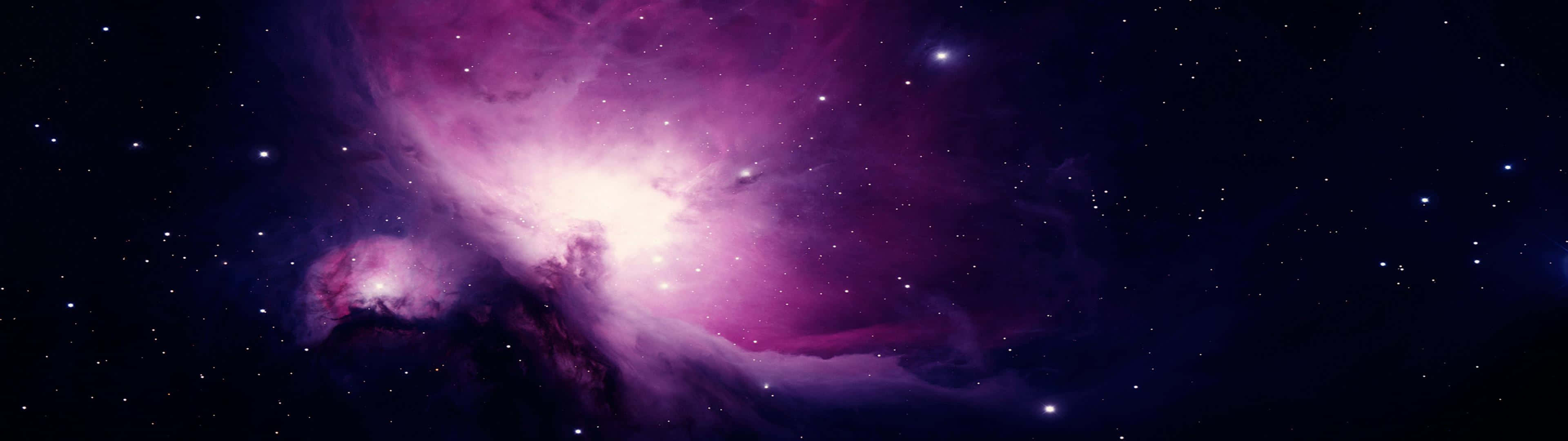 A Purple Nebula In Space With Stars Background