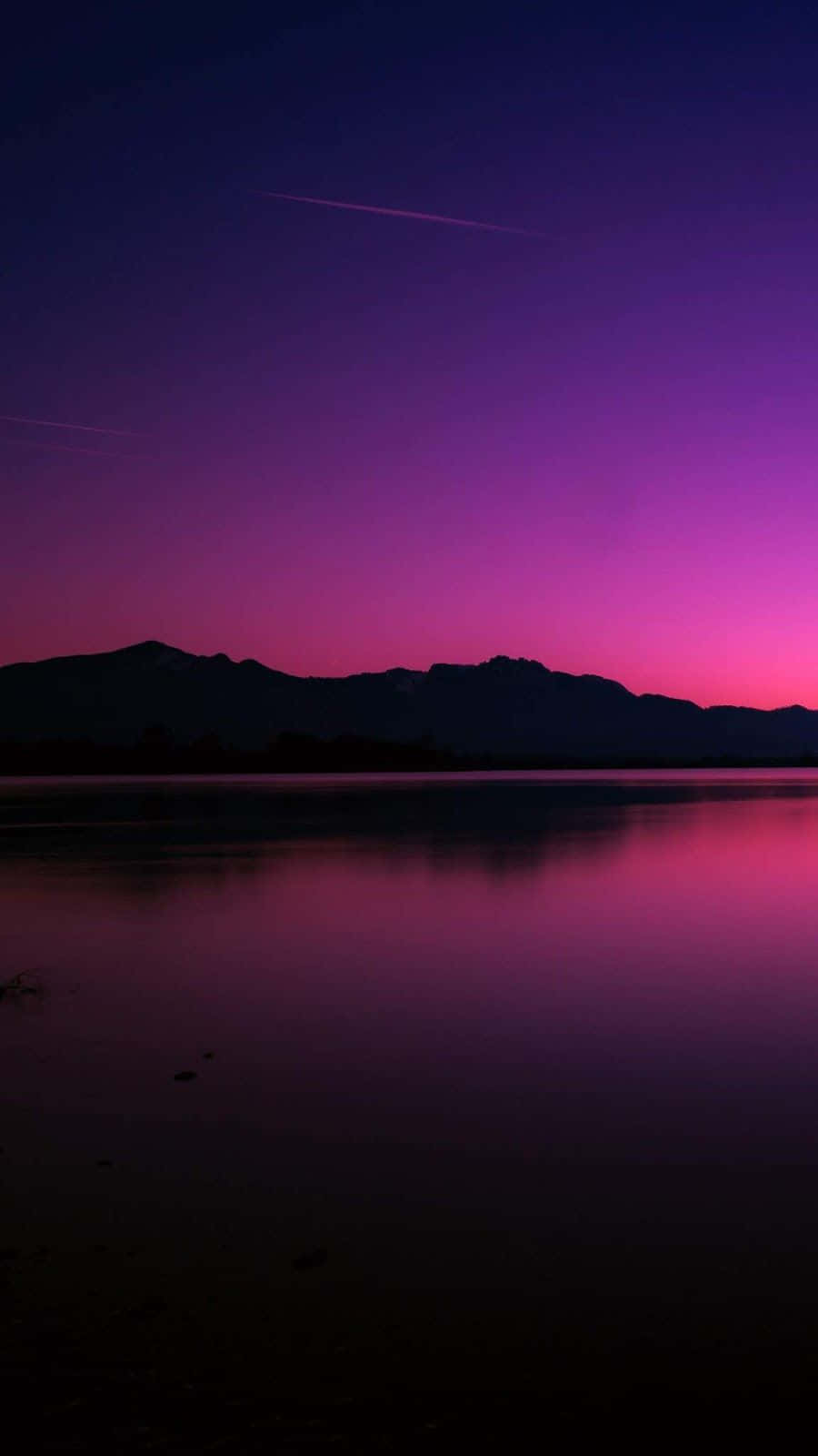 A Purple Sky With Mountains Background