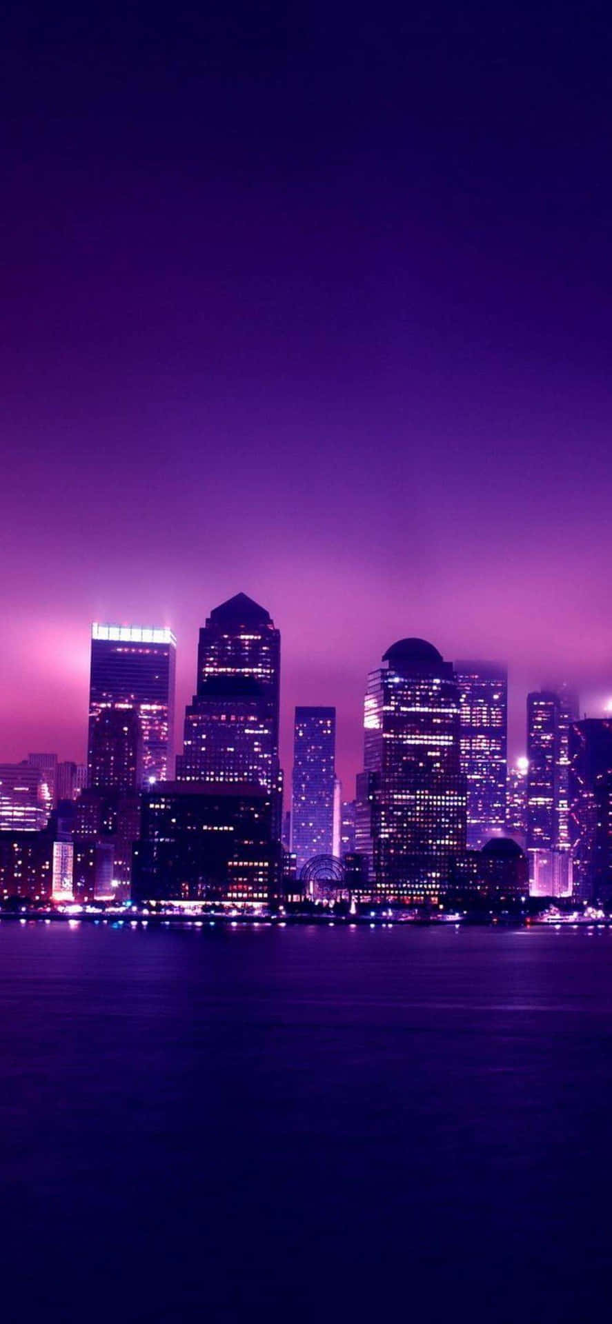 A Purple Skyline With Buildings And Lights Background