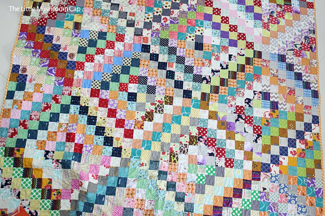 A Quilt With A Colorful Pattern On It Background