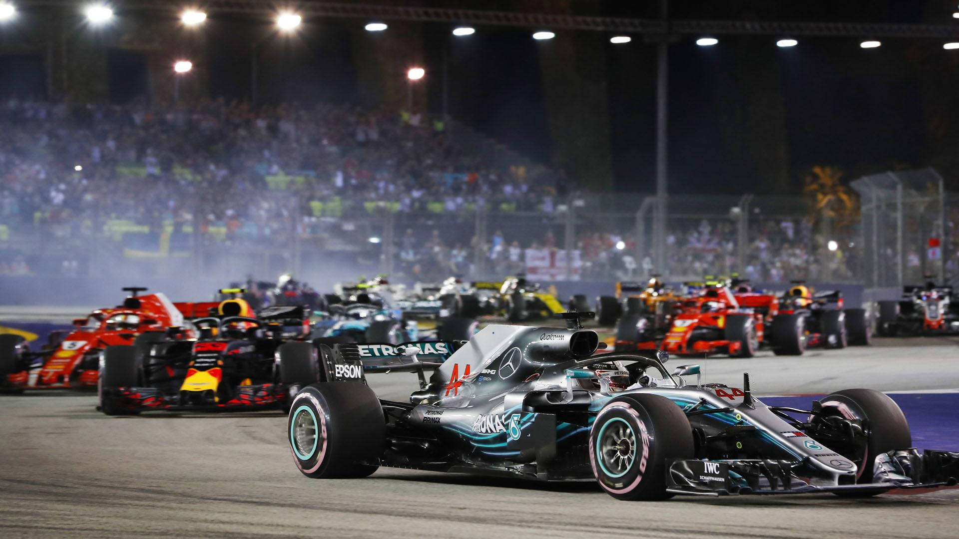 A Race Of Racing Cars On A Track Background