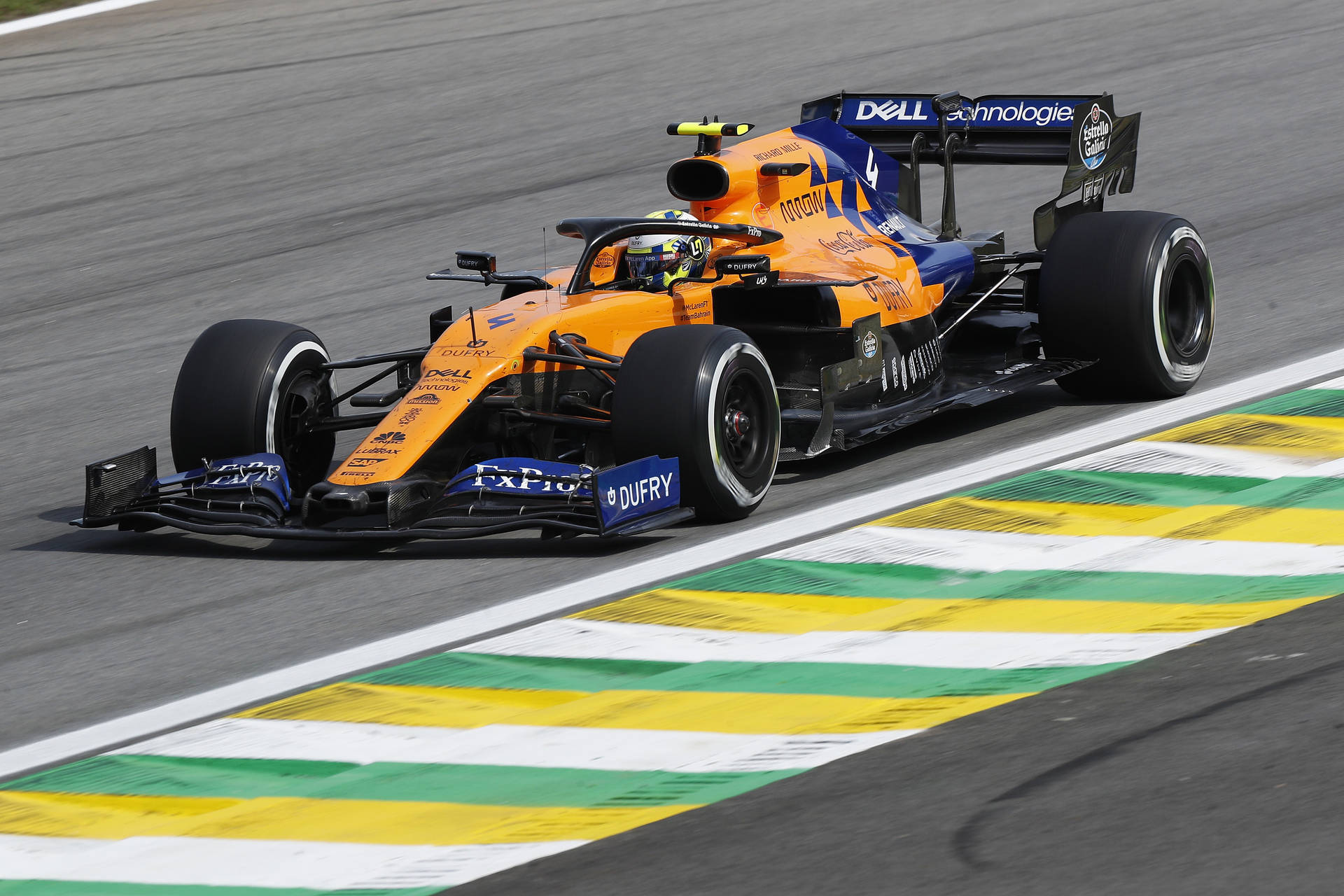 A Racing Car Driving Down A Track Background