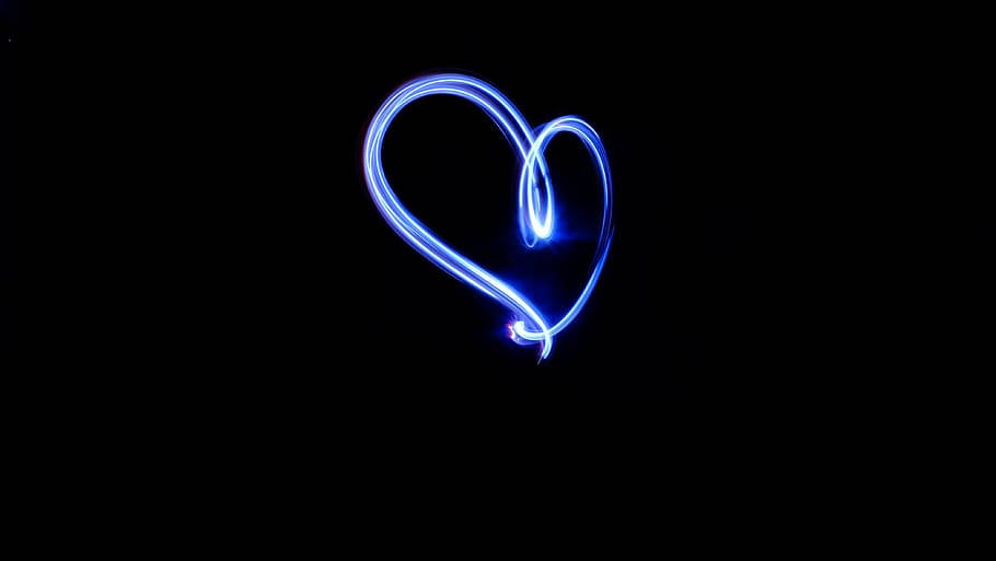 A Radiant Blue Heart Glowing In The Mystical Fog. Background
