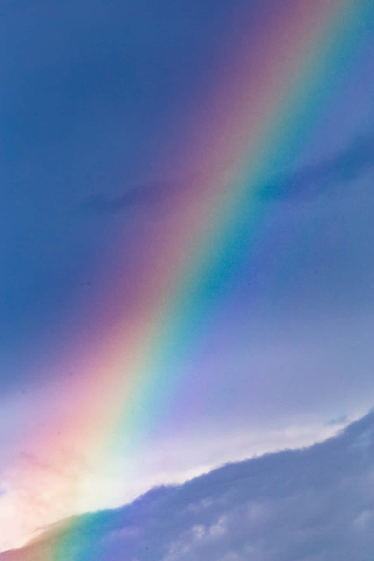 A Rainbow Is Seen In The Sky Above A Field Background