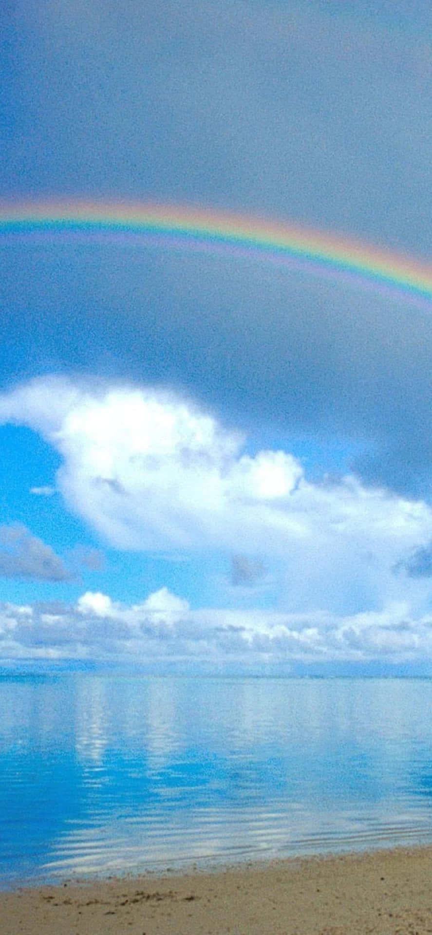 A Rainbow Over A Beach Background