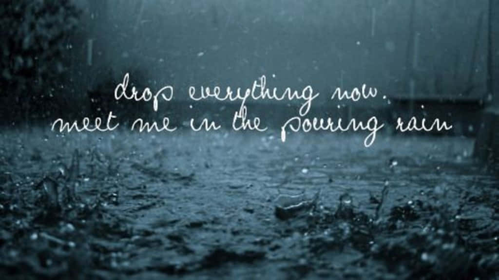 A Rainy Day With The Words, Everything Now Meet Me In The Pouring Rain Background