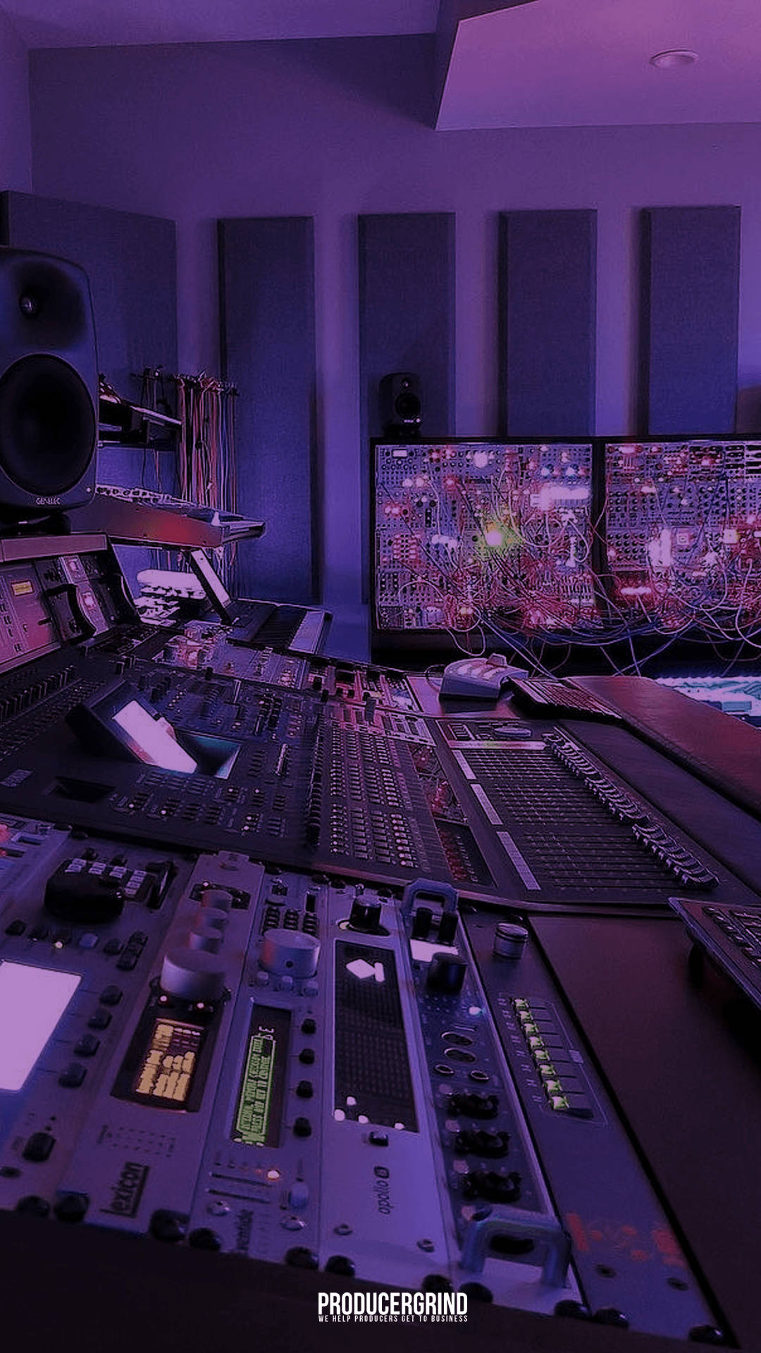 A Recording Studio With A Purple Light And Equipment Background