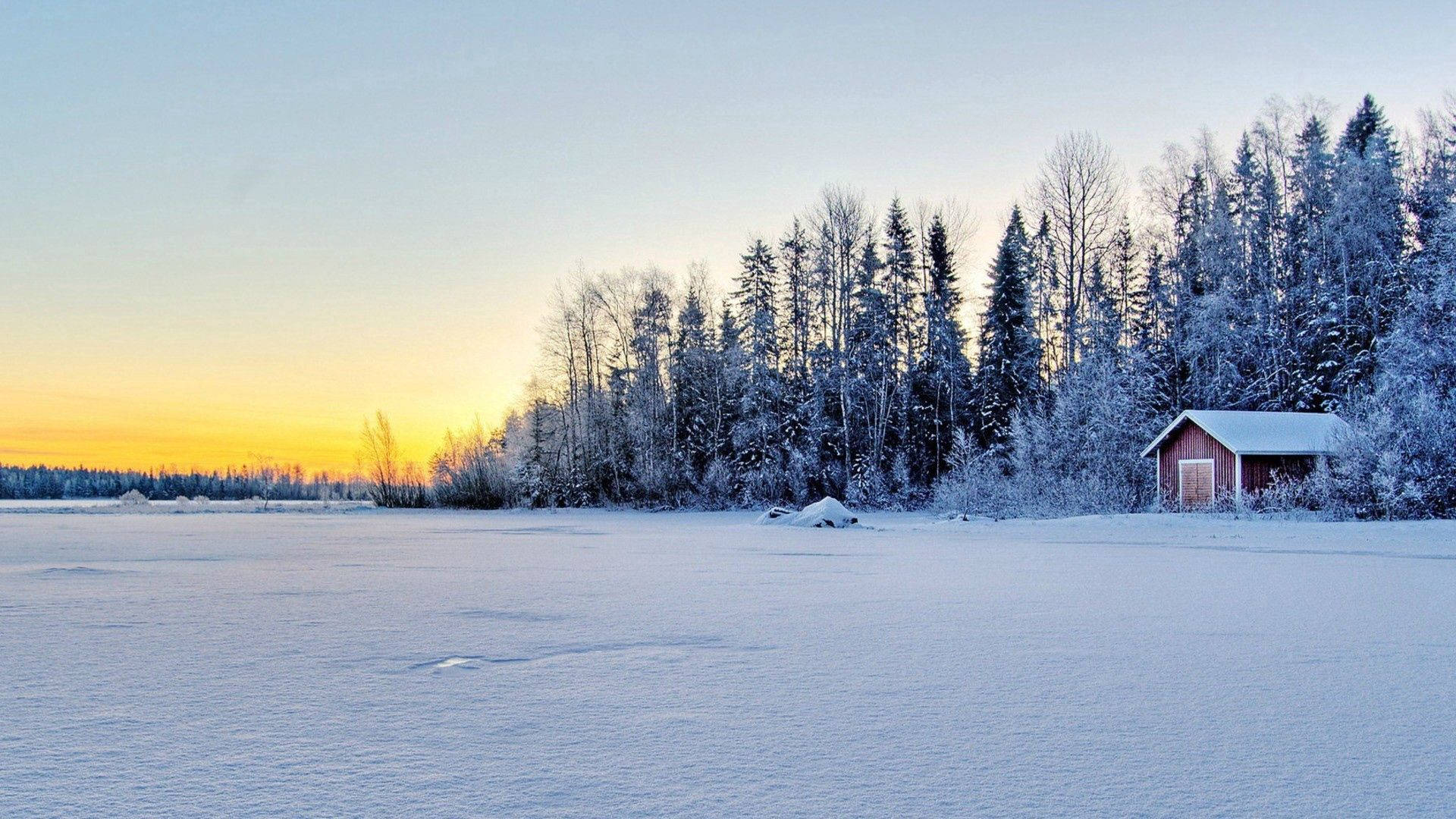 A Red Barn In The Snow With Trees In The Background Background