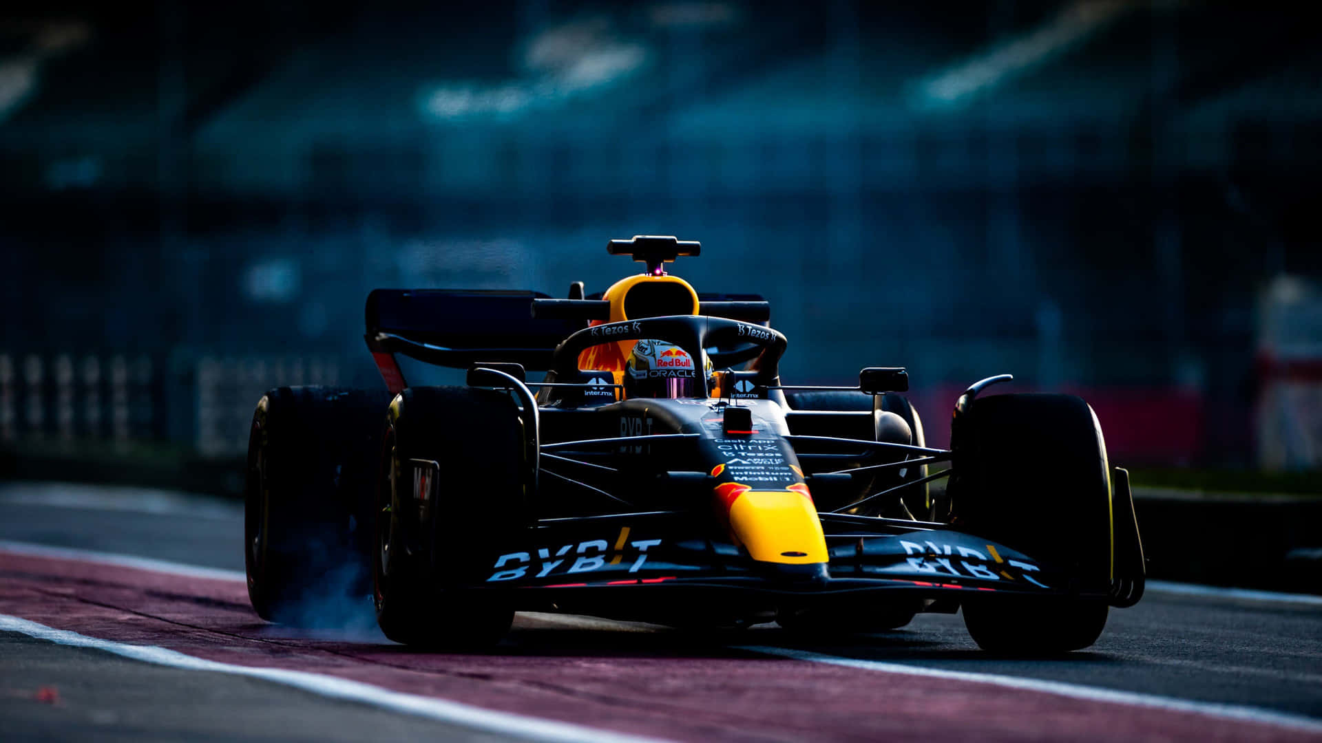 A Red Bull Racing Car Is Driving On A Track