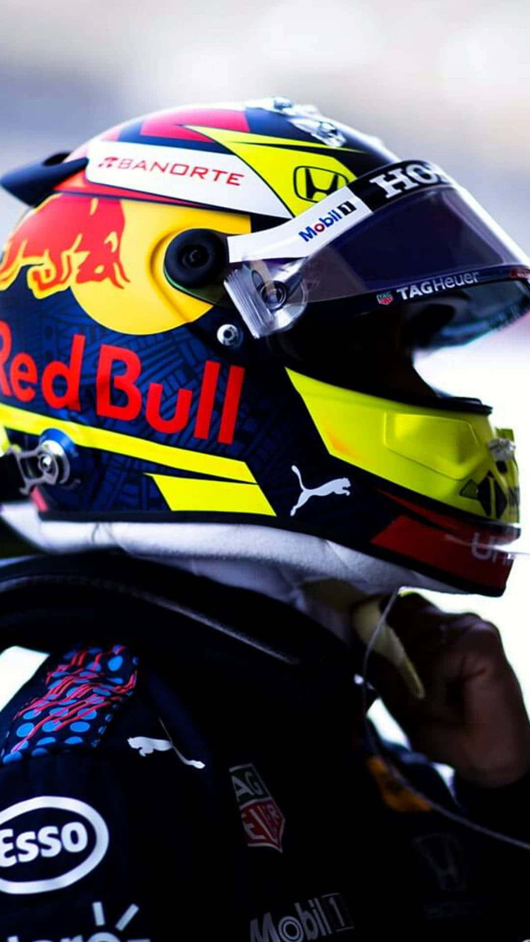 A Red Bull Racing Driver Is Wearing A Helmet Background