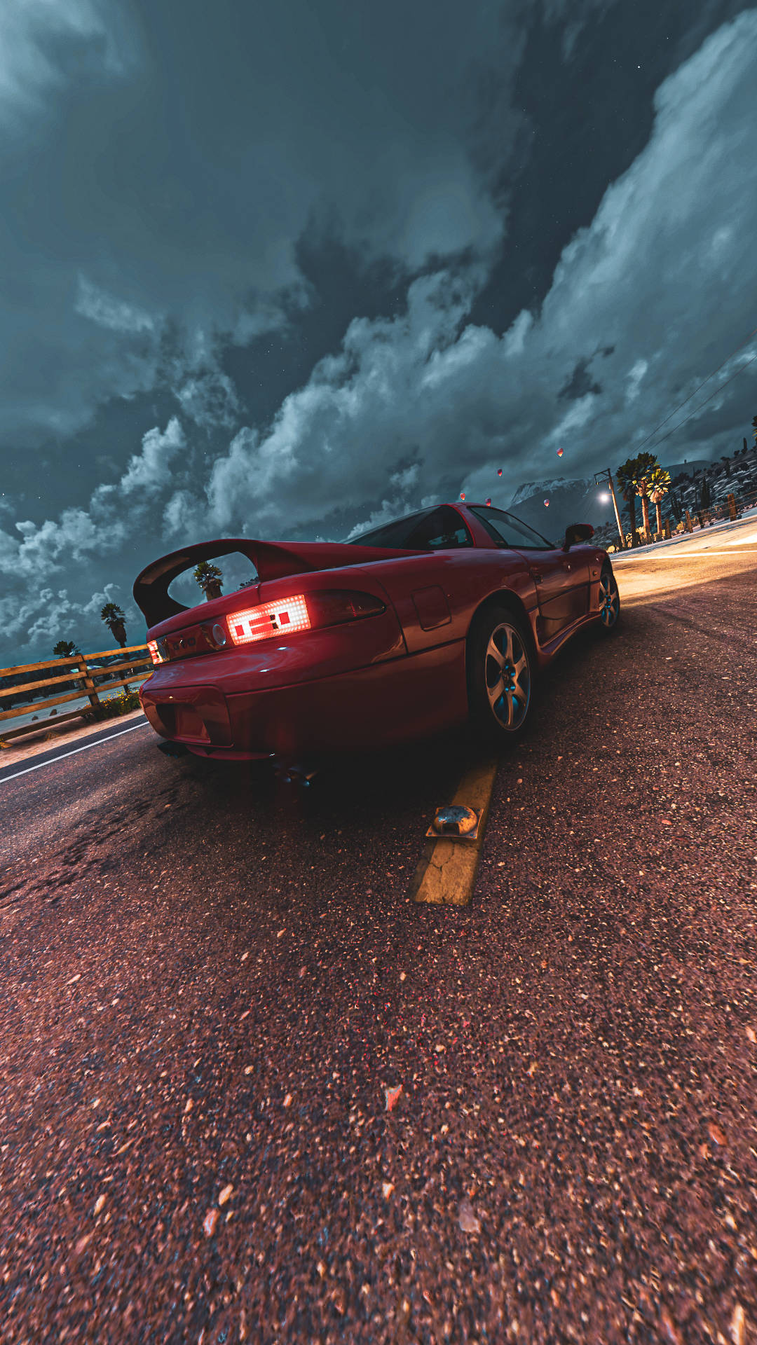 A Red Car Driving Down The Road Background