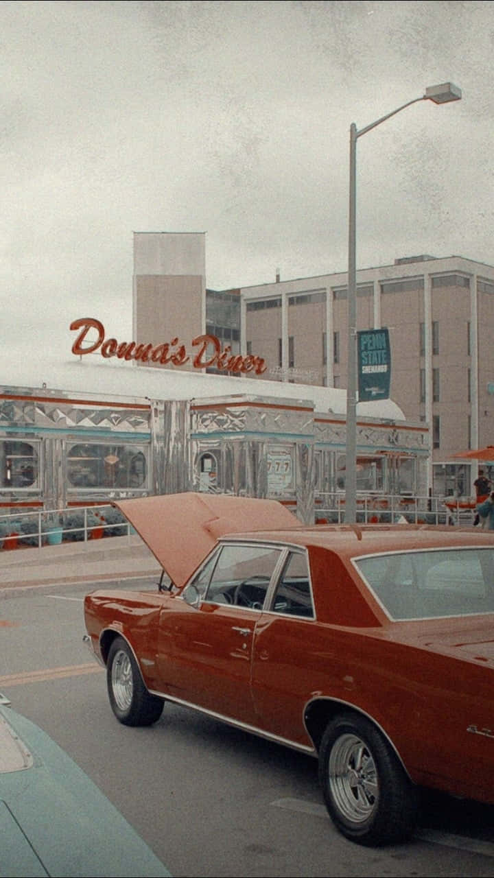 A Red Car In Front Of A Diner