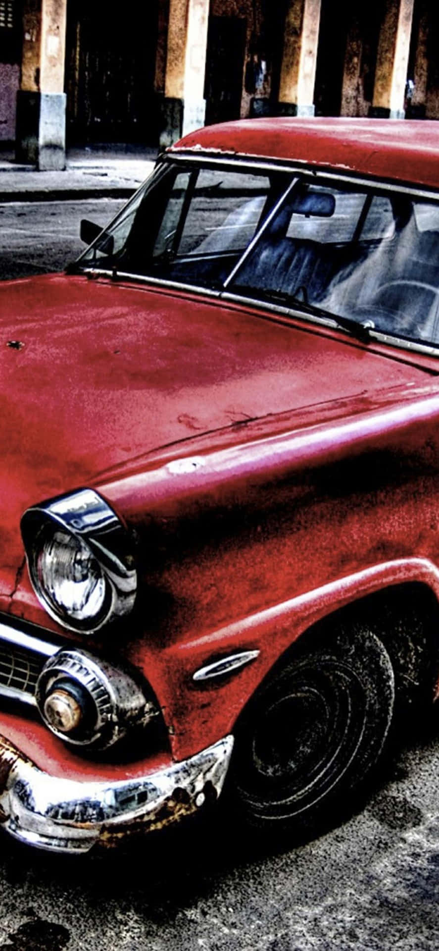 A Red Car Is Parked In Front Of A Building Background