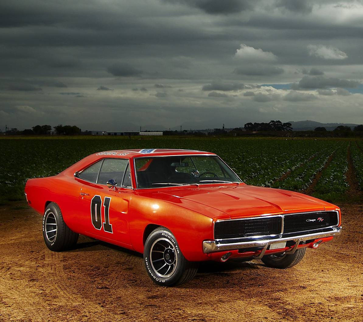 A Red Car Parked On A Dirt Road Background