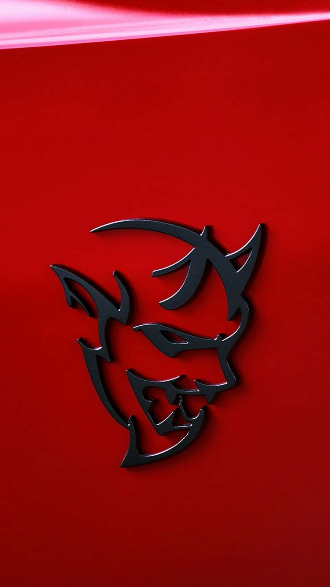A Red Car With A Devil Hood Emblem Background