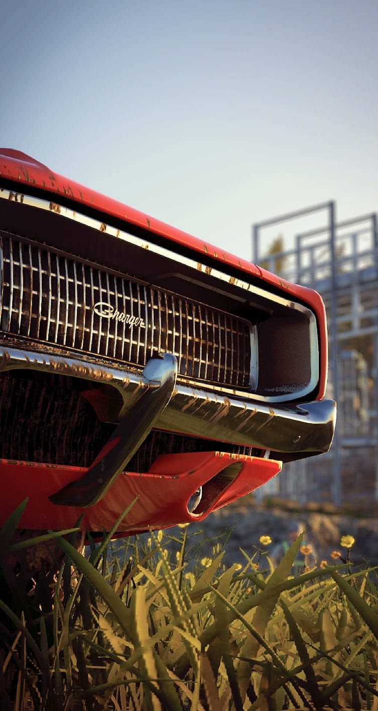 A Red Car With A Grill In The Grass