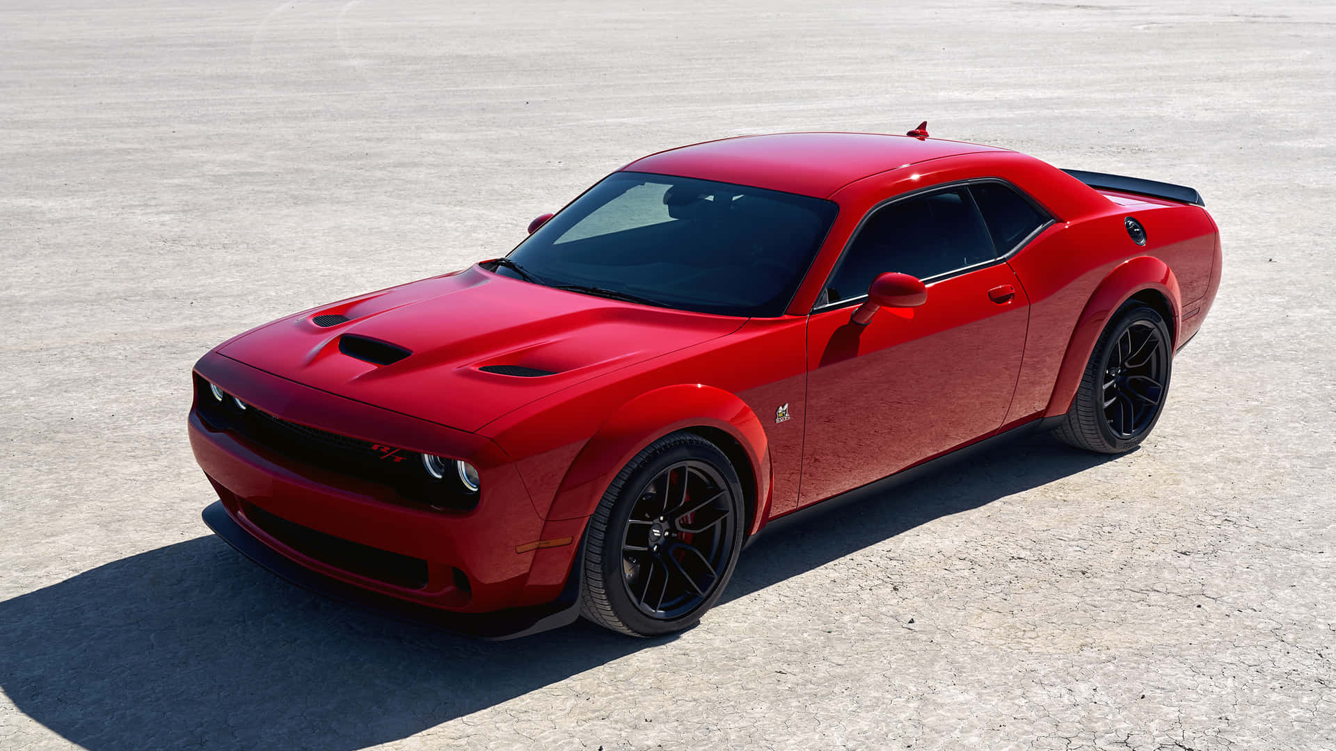 A Red Dodge Challenger Parked In A Parking Lot Background