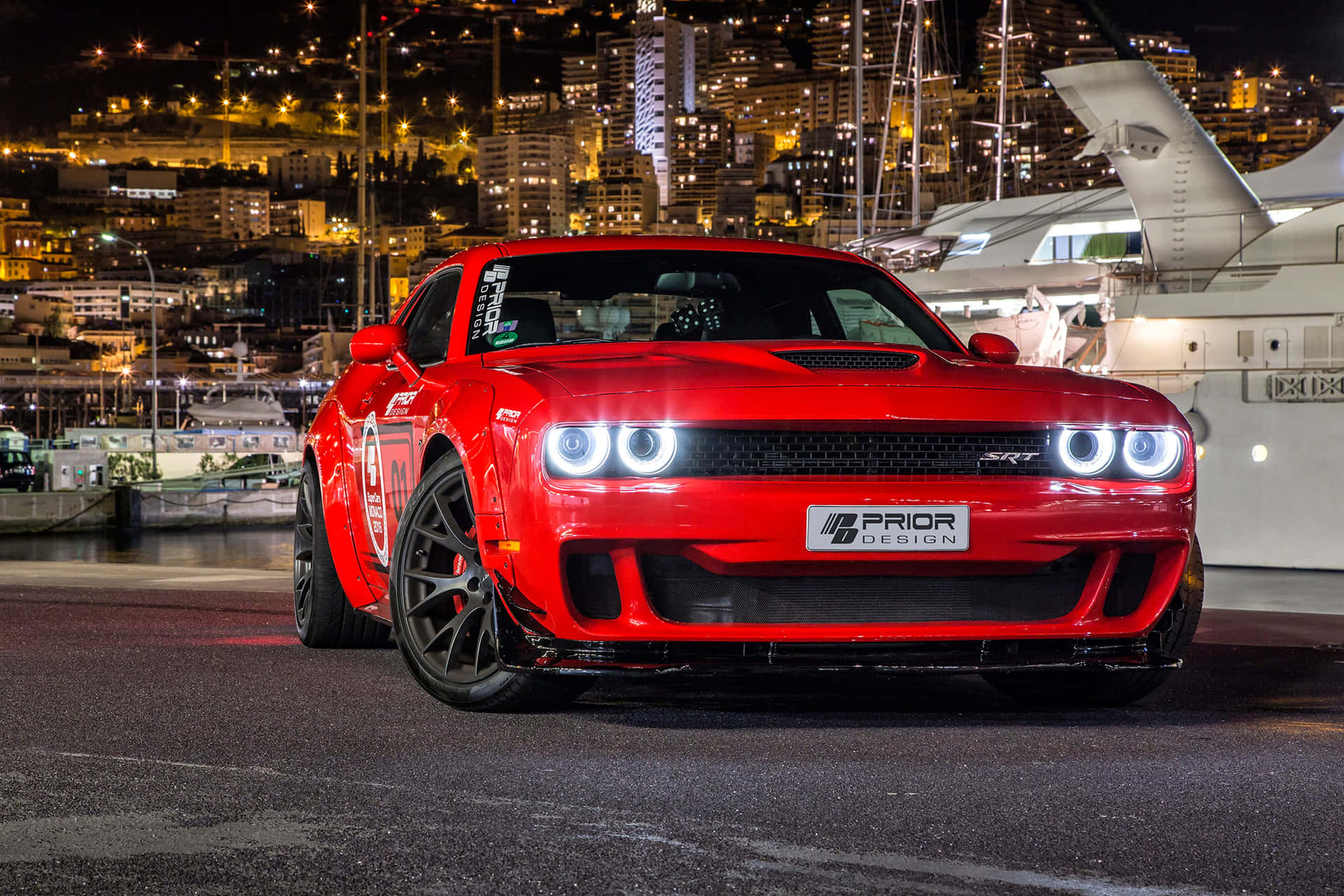 A Red Dodge Demon Parked In Front Of A Yacht Background