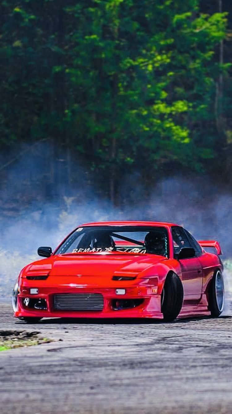 A Red Drift Car Driving Down A Track Background