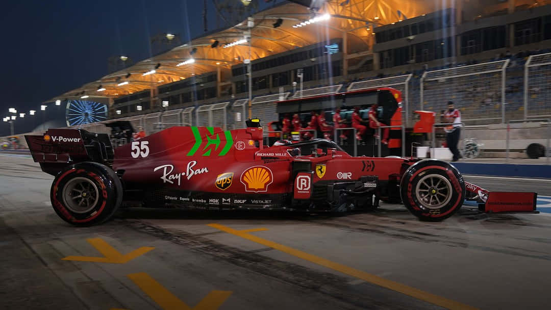A Red Ferrari F1 Racecar Speeding On A Track. Background