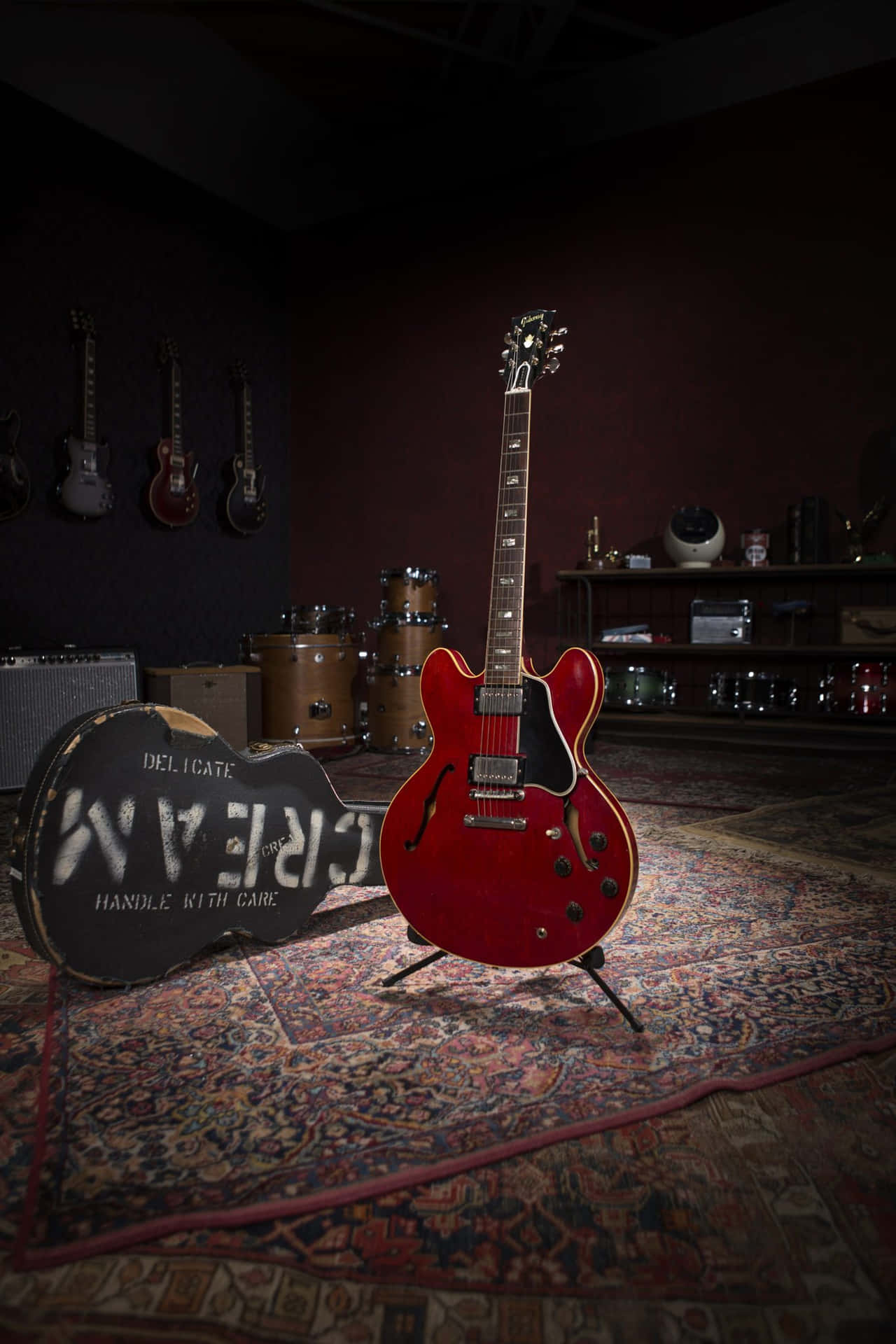 A Red Guitar Is Sitting On A Rug In A Room Background