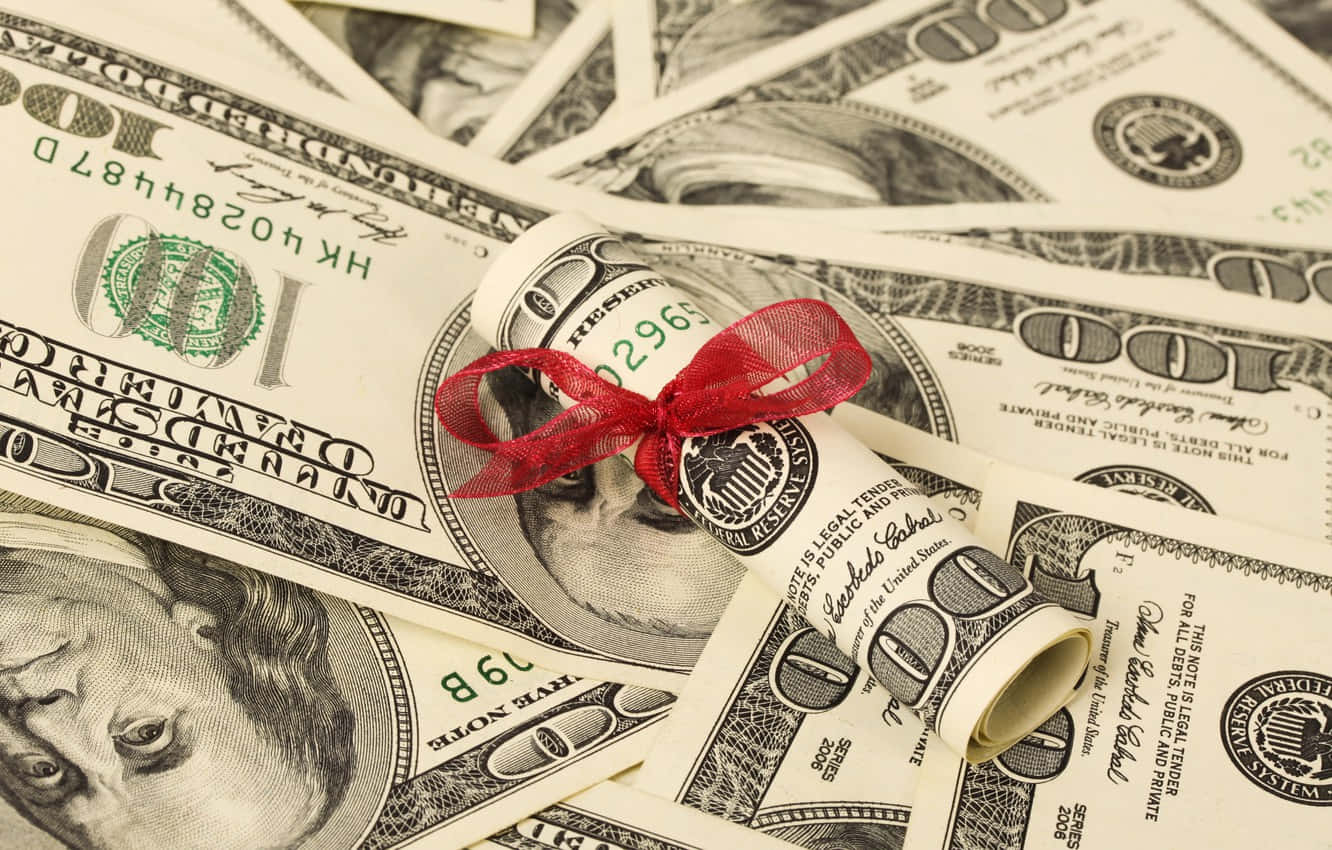 A Red Ribbon Is Tied Around A Bundle Of Money Background