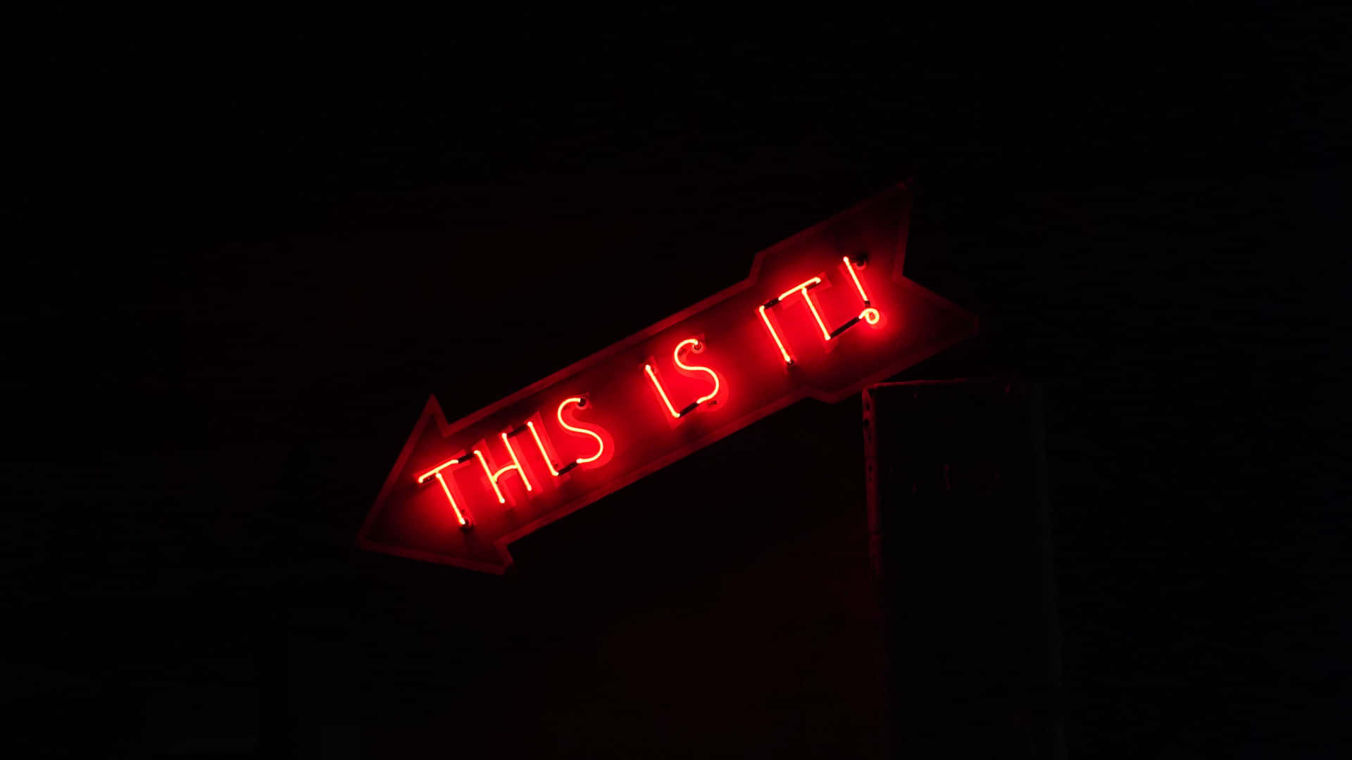 A Red Sign On A Pole