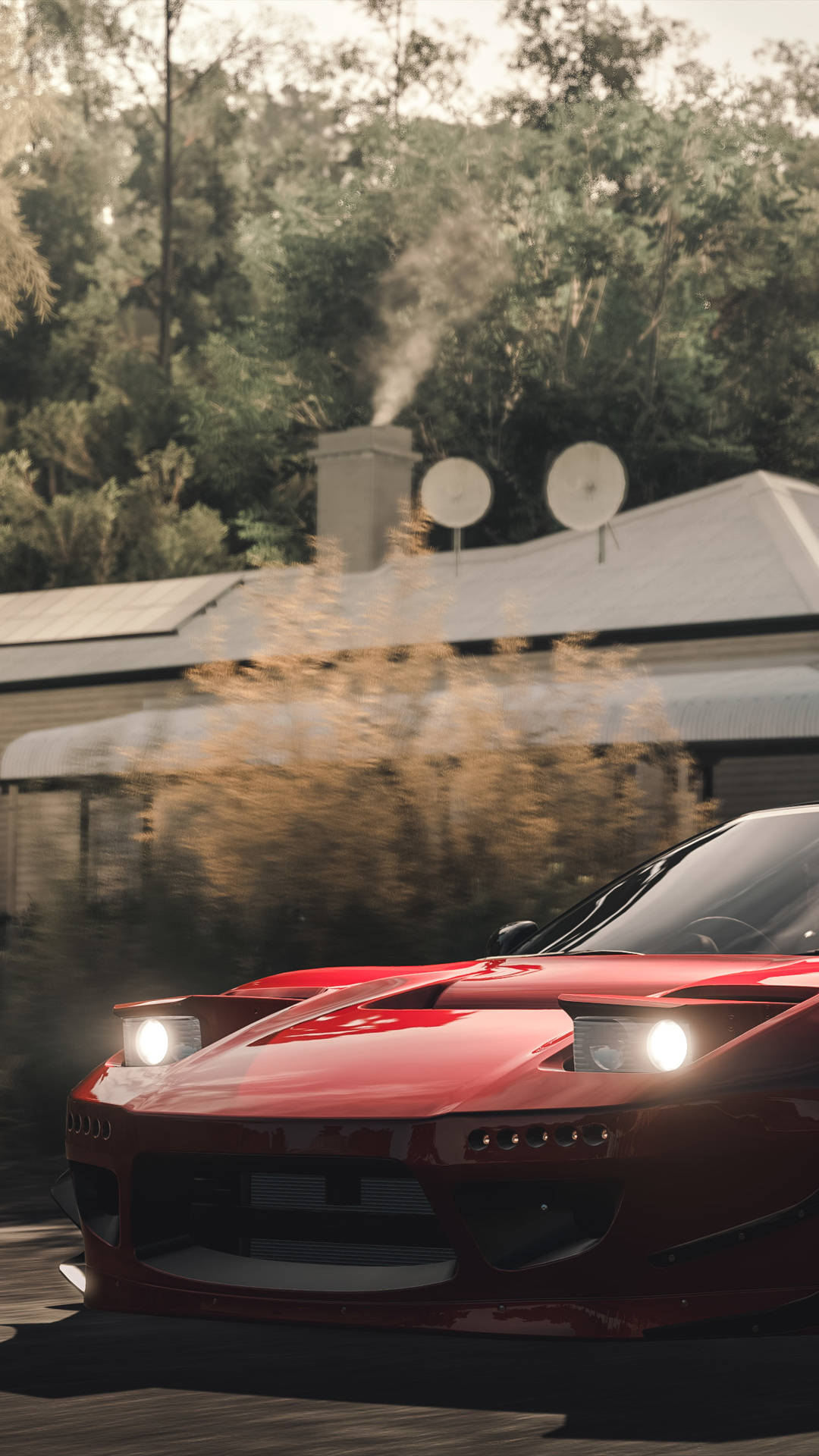 A Red Sports Car Driving Down A Road Background