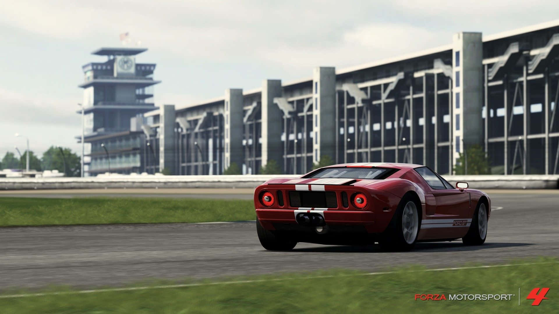 A Red Sports Car Driving On A Race Track Background