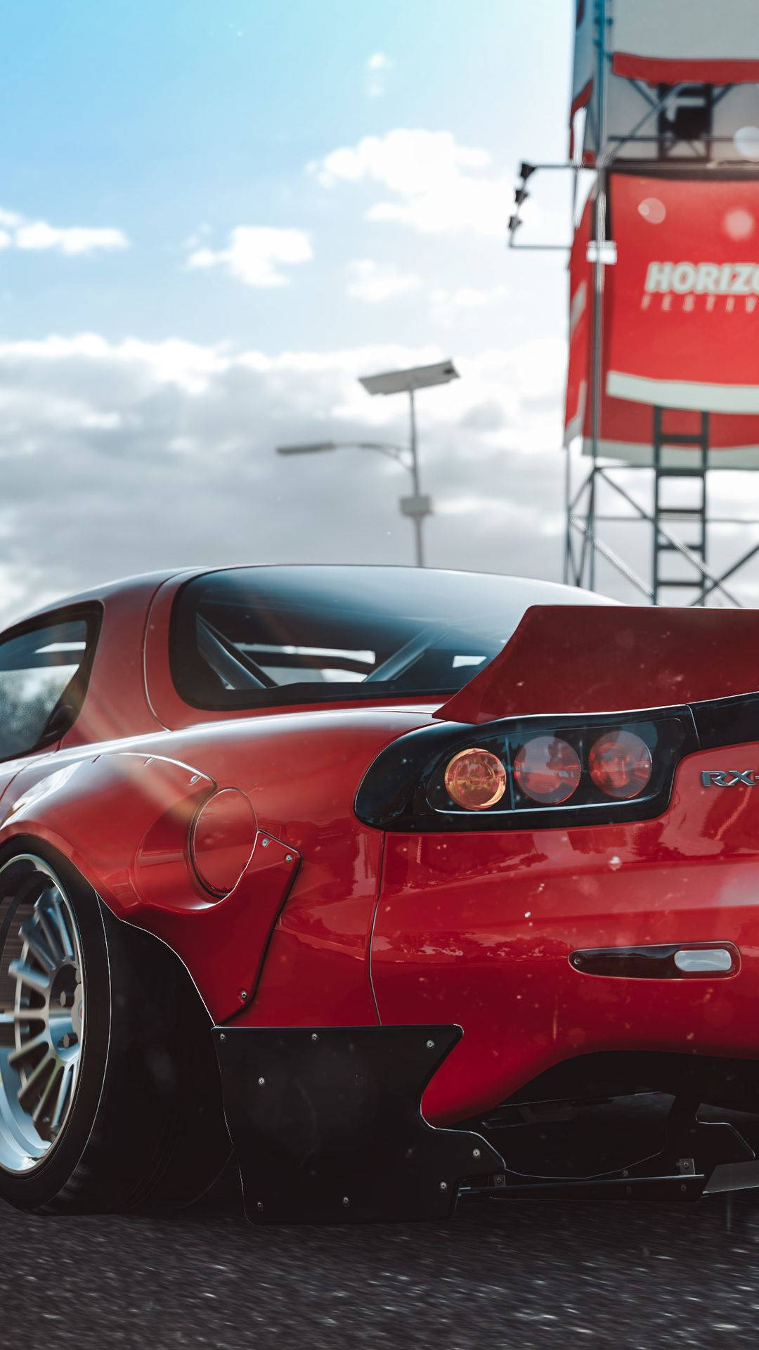 A Red Sports Car Is Parked In A Parking Lot Background