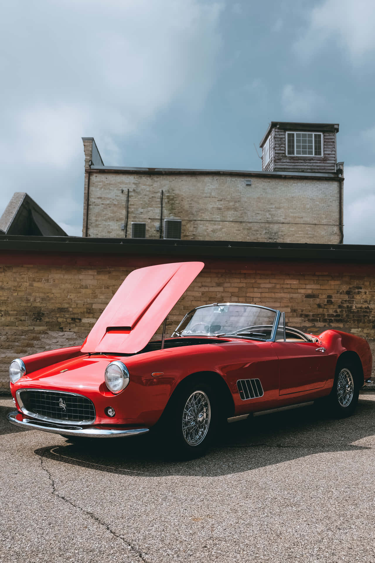 A Red Sports Car Parked In Front Of A Building