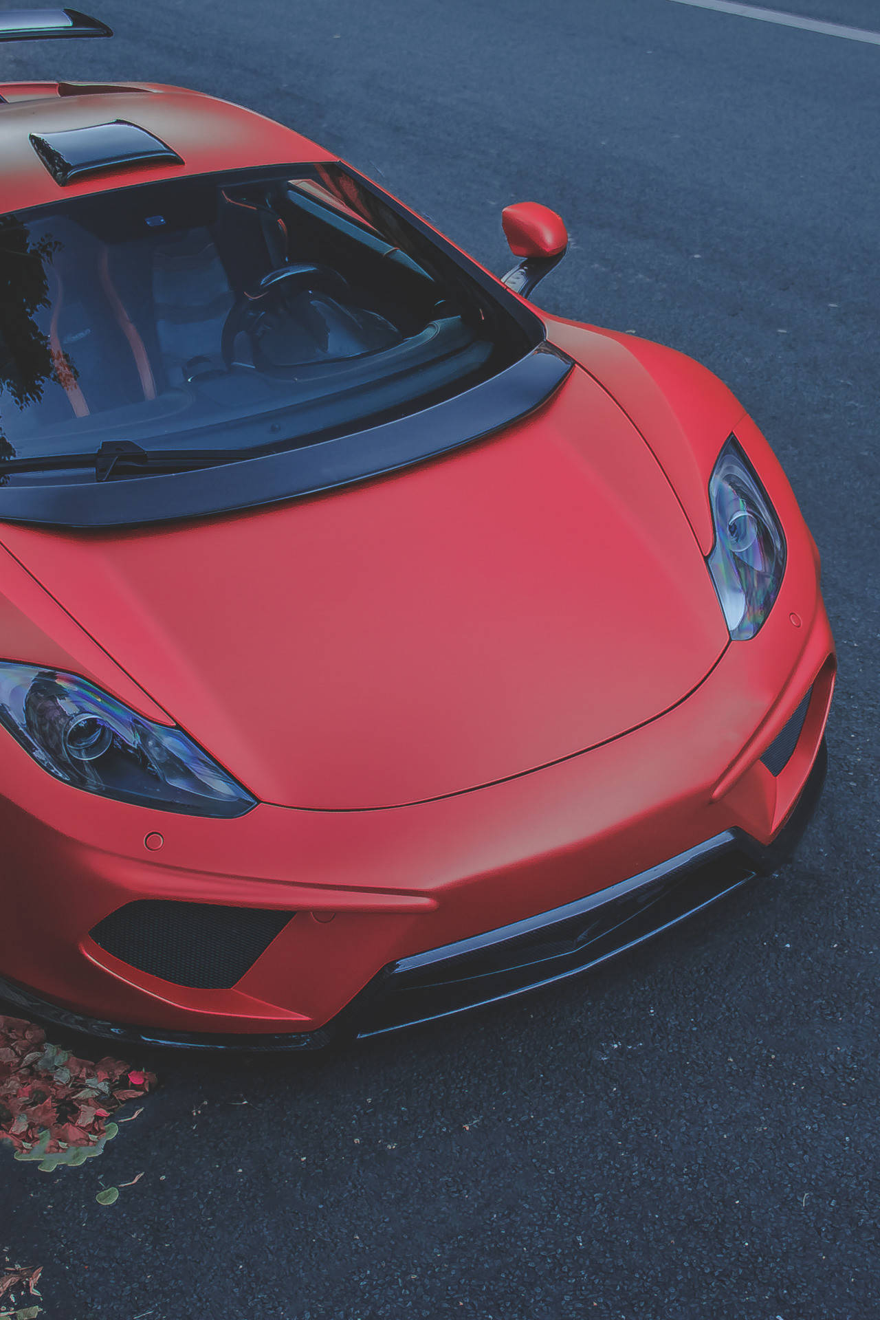 A Red Sports Car Parked On The Street Background