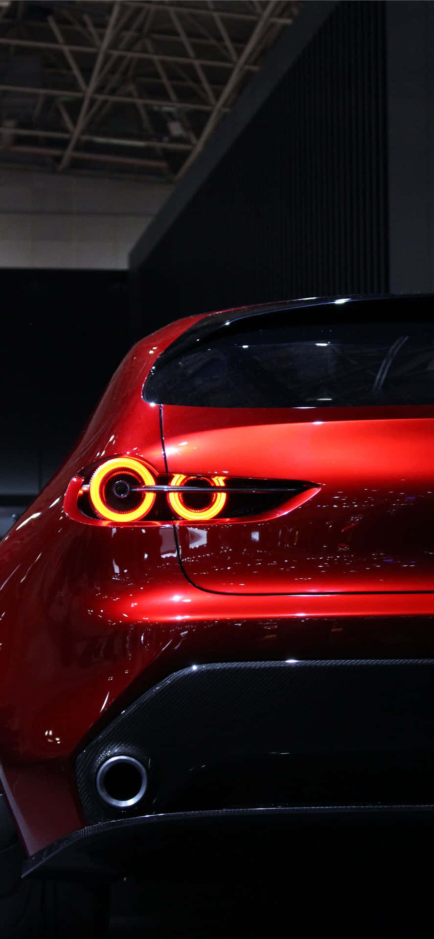 A Red Sports Car With A Red Tail Light Background