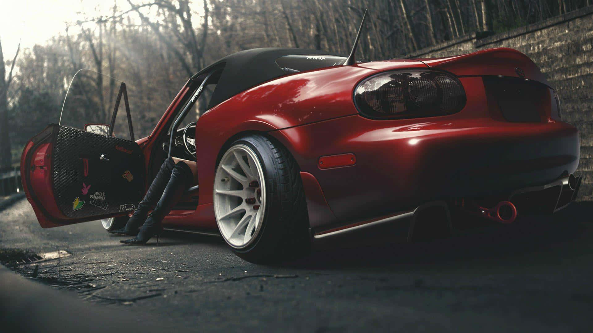 A Red Sports Car With Its Door Open Background