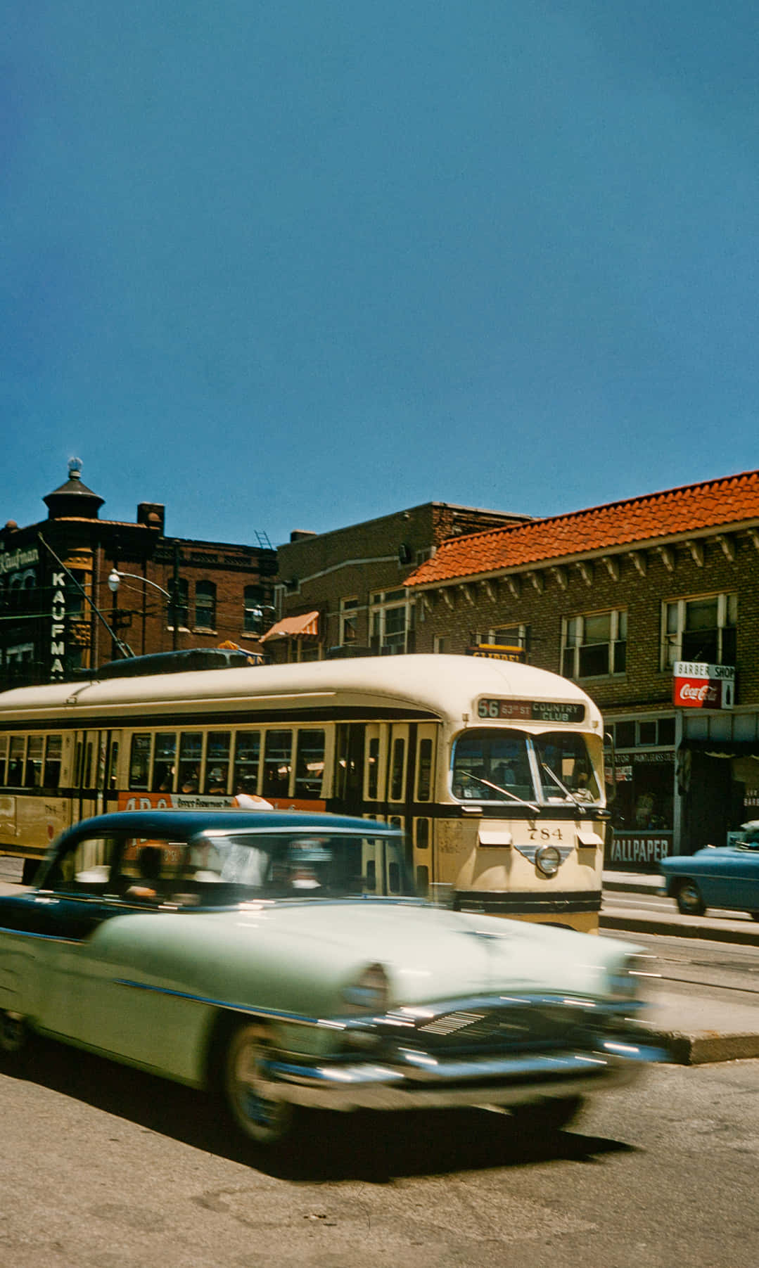 A Red Streetcar Train Passing Through Main Street In Kansas City