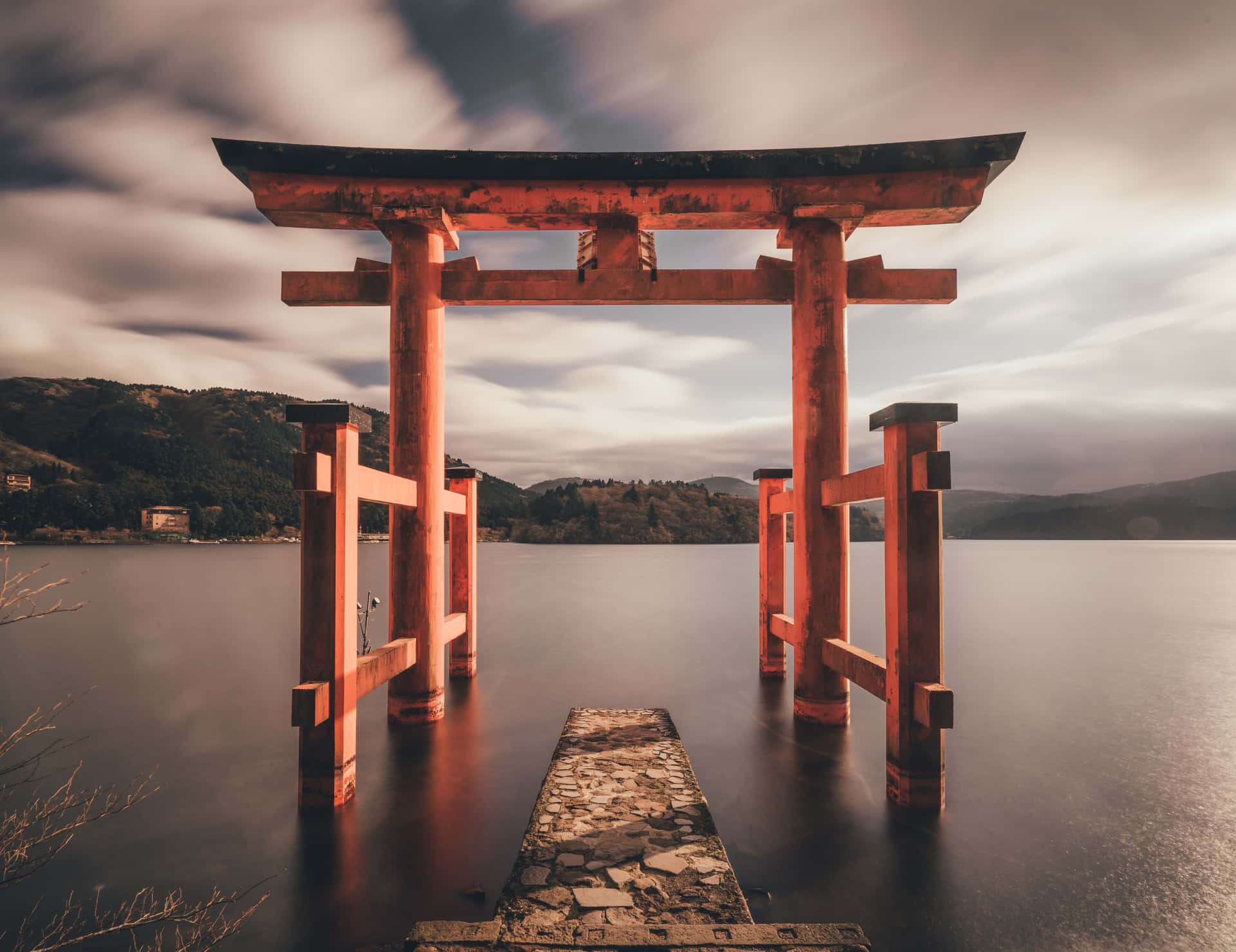 A Red Tori Gate Is Standing In The Water Background