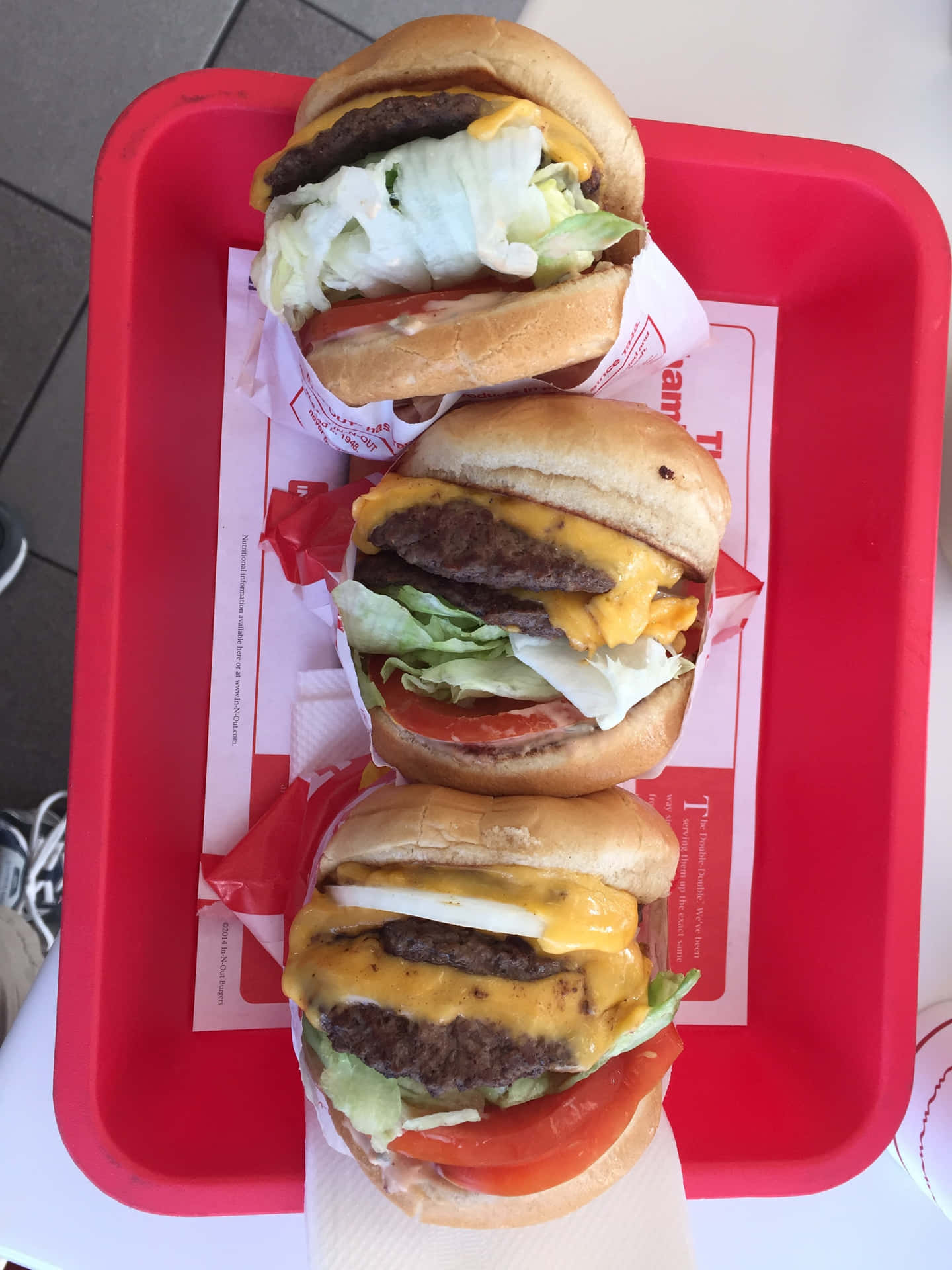 A Red Tray With Three Hamburgers On It Background