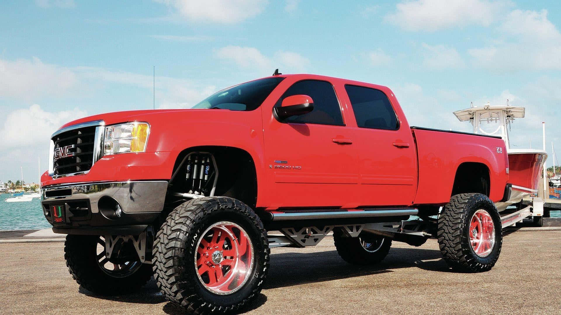 A Red Truck With A Large Set Of Wheels