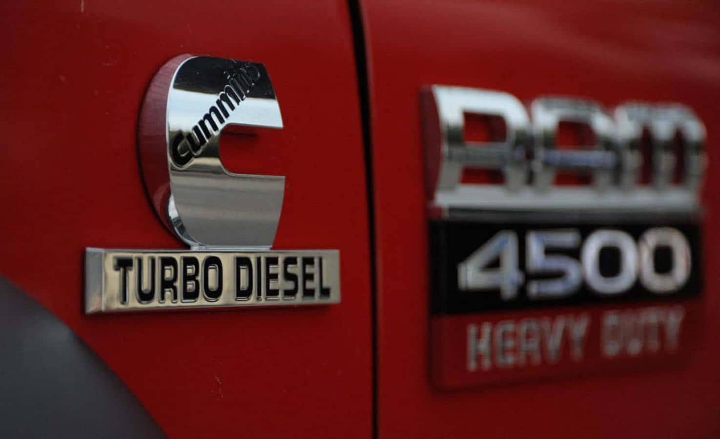 A Red Truck With A Logo That Says Turbo Diesel Background