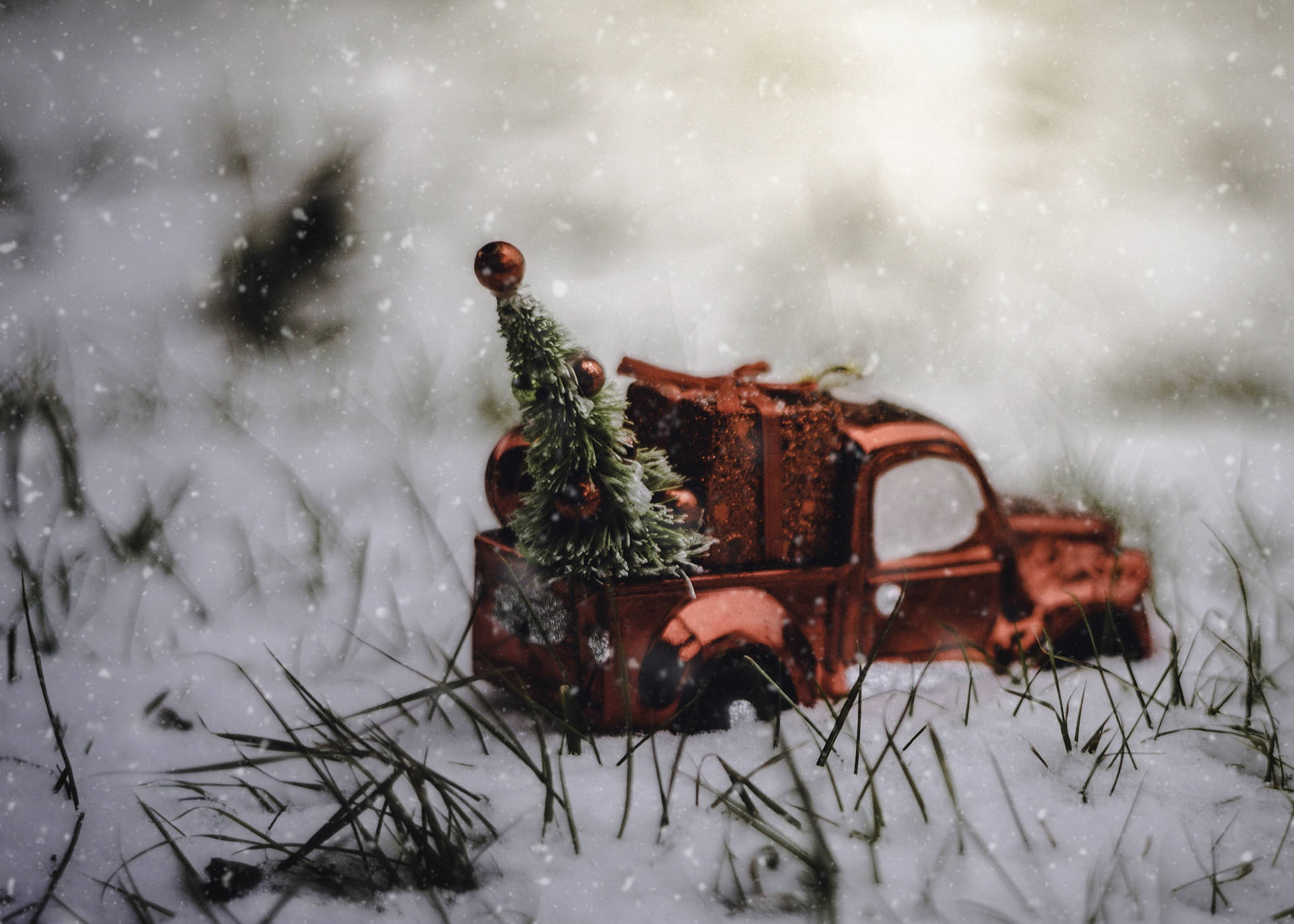 A Red Truck With Christmas Tree In The Snow Background