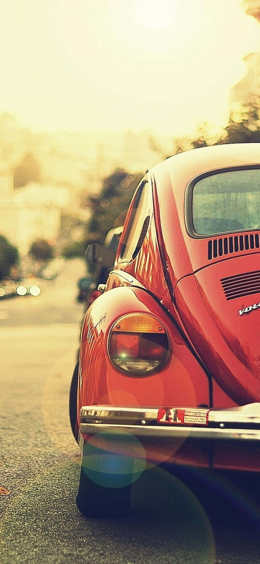 A Red Volkswagen Beetle Parked On The Street