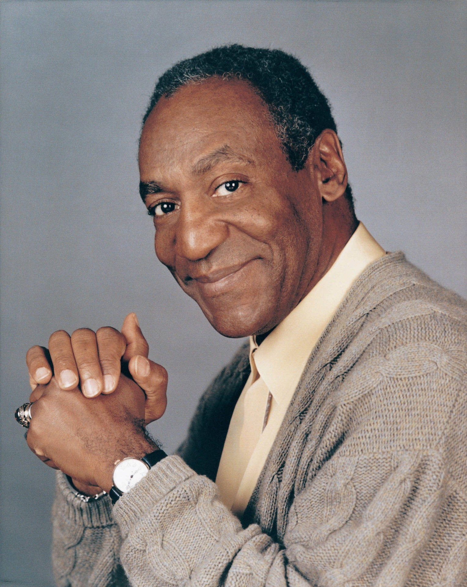 A Reflective Bill Cosby Clasping His Hands